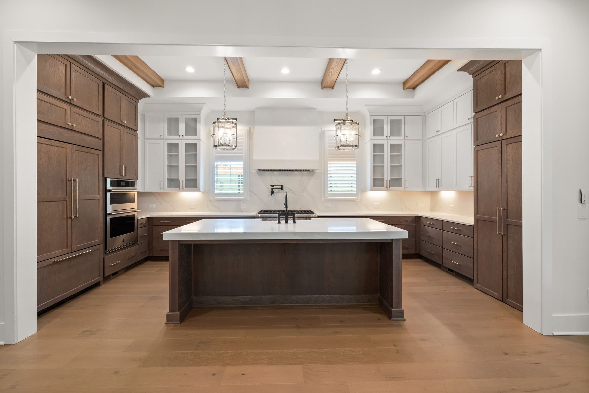 Luxury kitchen with oak ceiling beams and a walnut island