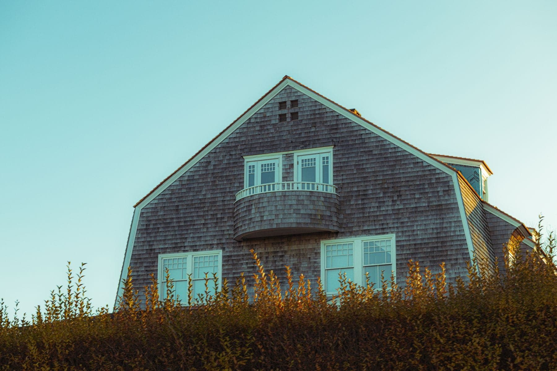 Silvered cedar shingle house against the sky, New England