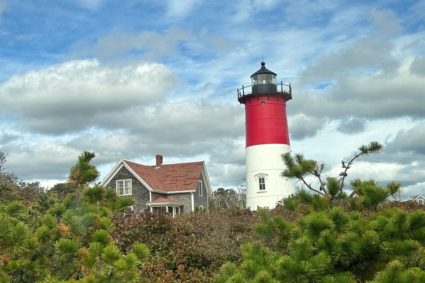 Nauset Light and its shingled keeper's house among the pines, Eastham