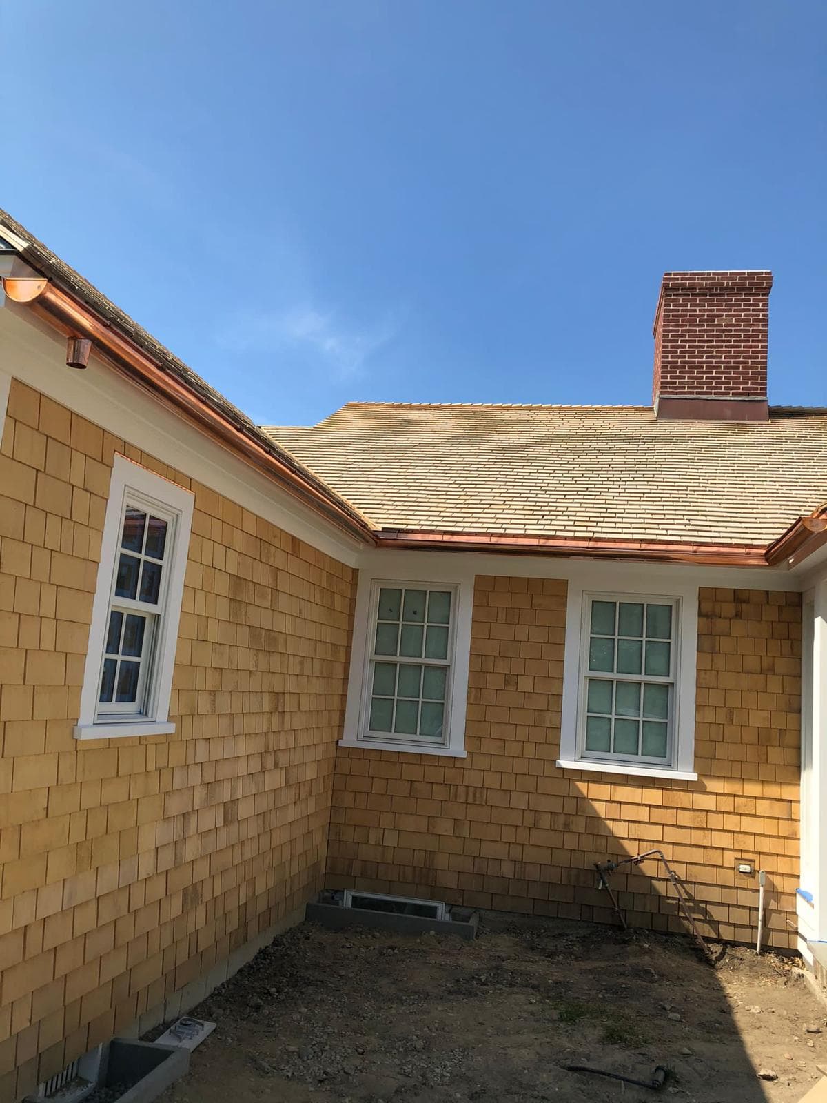 New cedar shingles and copper gutters