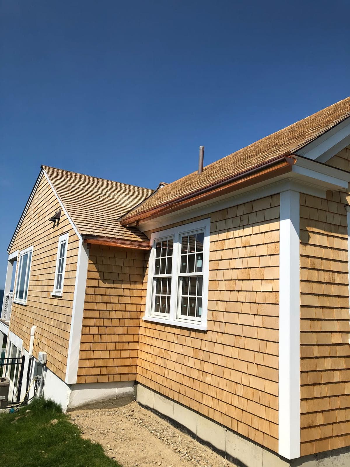 Fresh cedar sidewall and white window casing