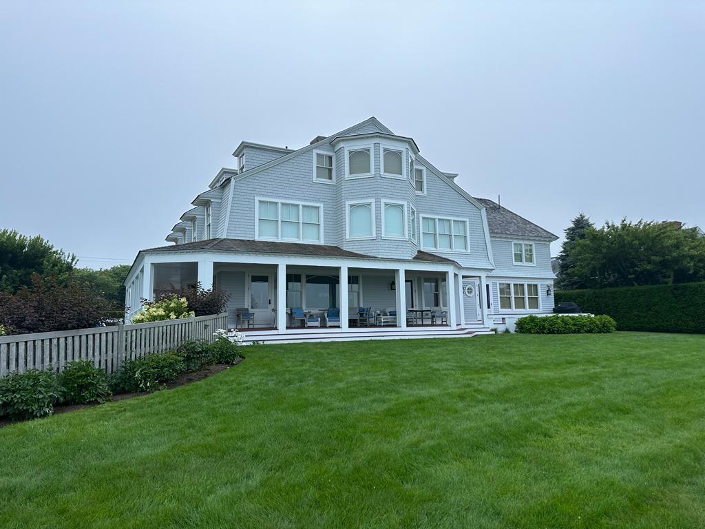 Shingle style home from the garden in sea fog