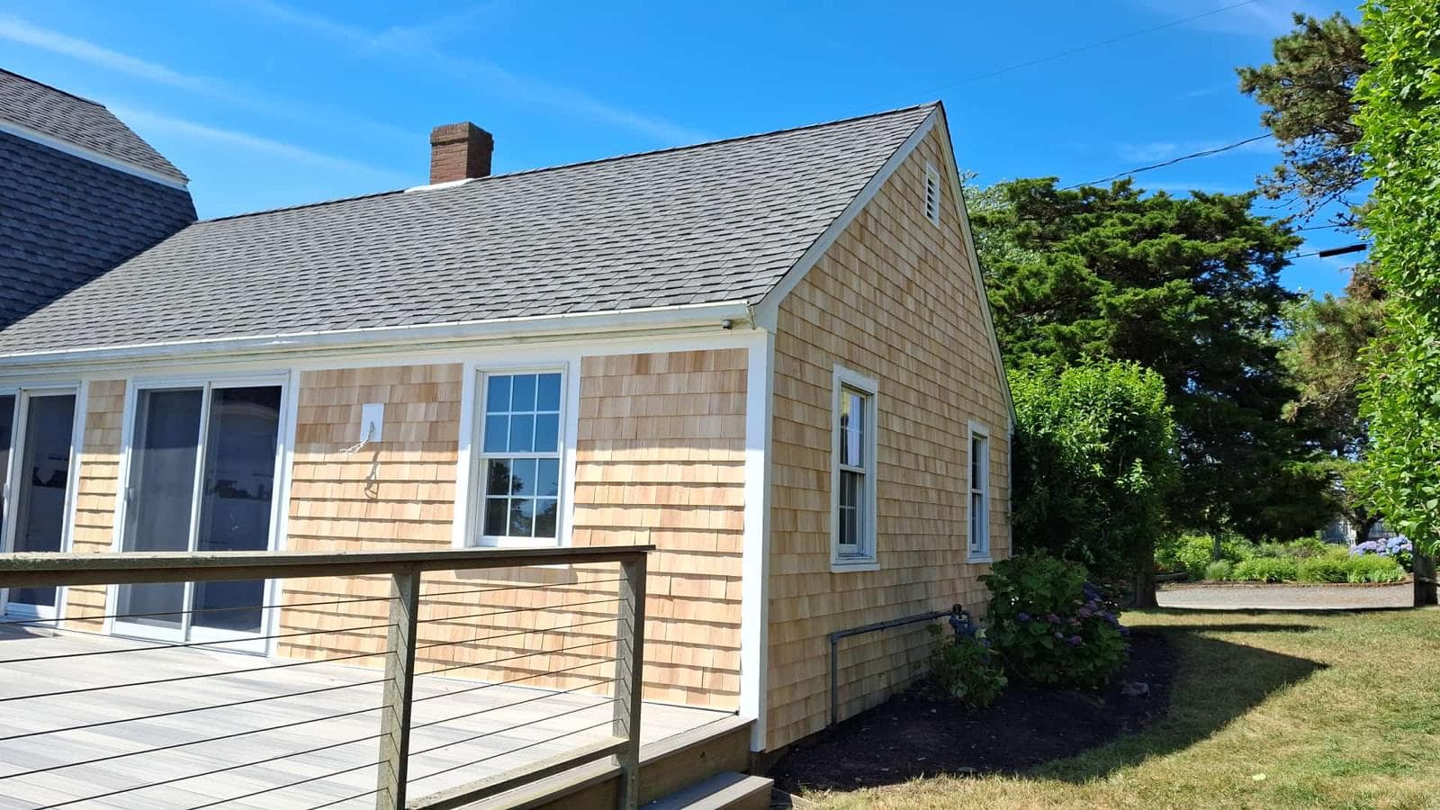 Cedar shingled cape by the water
