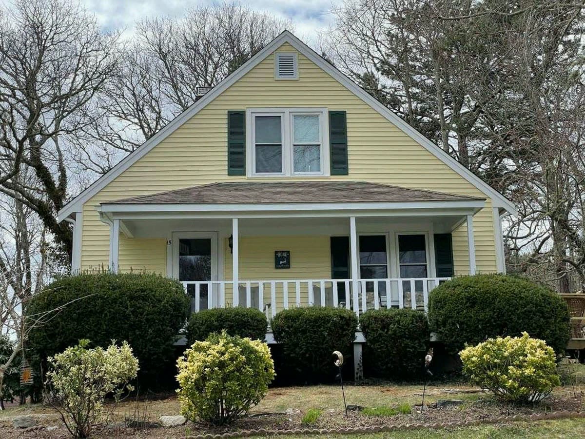 Classic Cape with rebuilt front porch and white rail