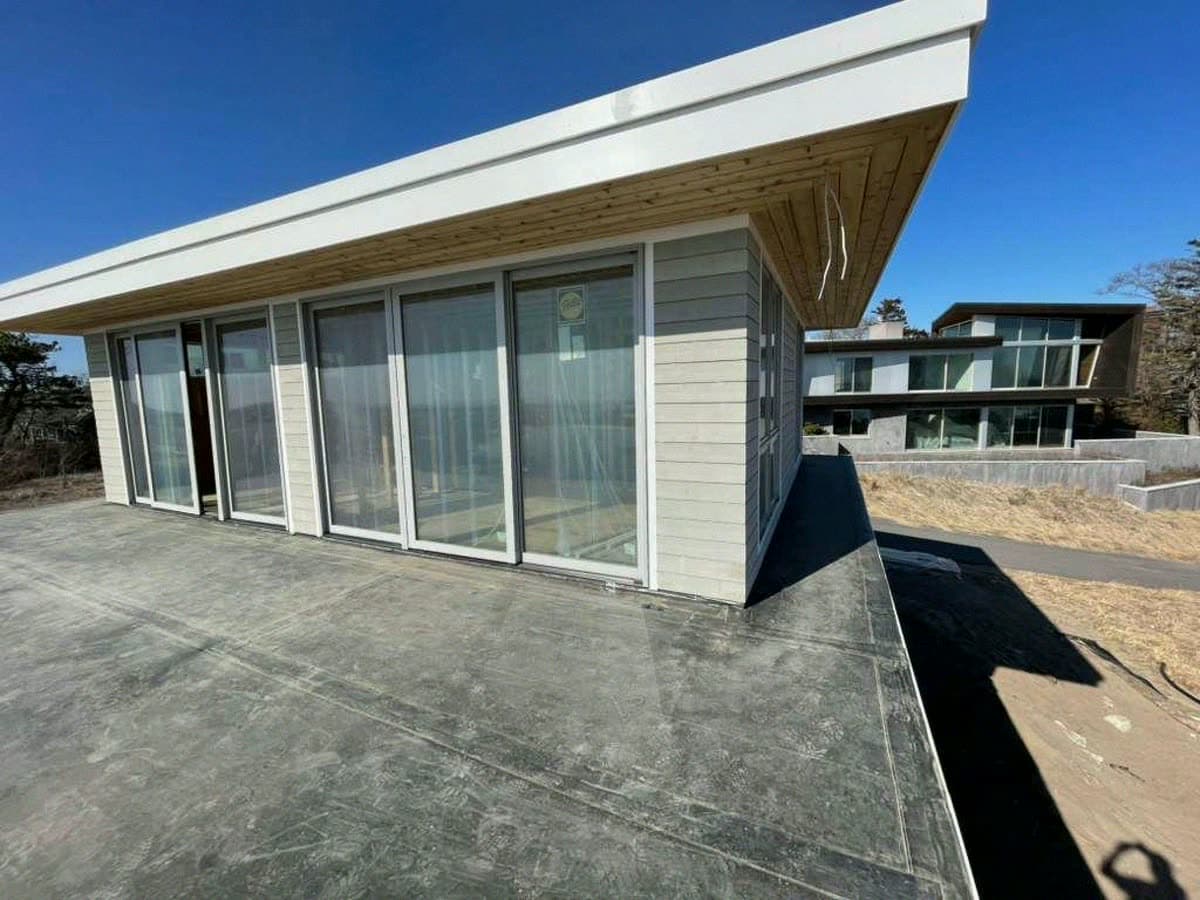 Modern flat roof build with cedar soffit and glass walls
